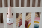 Beaba Pixie Torch hanging from a cot rail